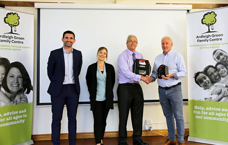 College teams up with Balfour Beatty to present life-saving defibrillator to community group